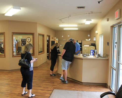 Customers at the front desk inside Collision Center. Our friendly and professional staff will help get you the auto body work you need, serving the Wichita area.