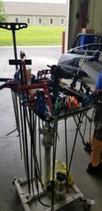 Collision Center of Andover tools for technician working on an auto body repair to handle paintless dent repair on a gold truck.