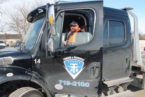 Tow truck driver in Collision Center of Andover’s towing service truck – serving Wichita area