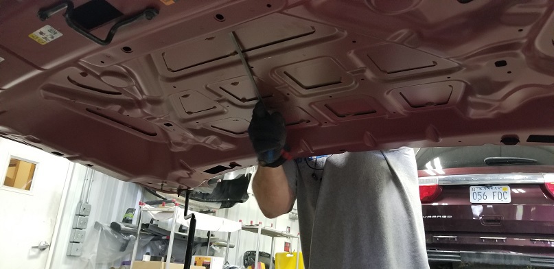 Under the hood of seeing paintless dent repair technician