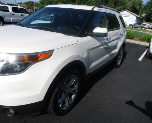 White Ford Explorer repaired with pdr door ding service from Collision Center of Andover