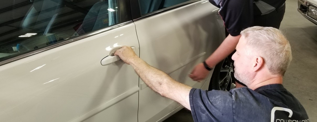 White car door damaged repaired by autobody technician at Collision Center of Andover, serving entire Wichita area