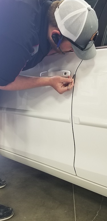 Collision Center of Andover autobody repair technician fixing dented car door